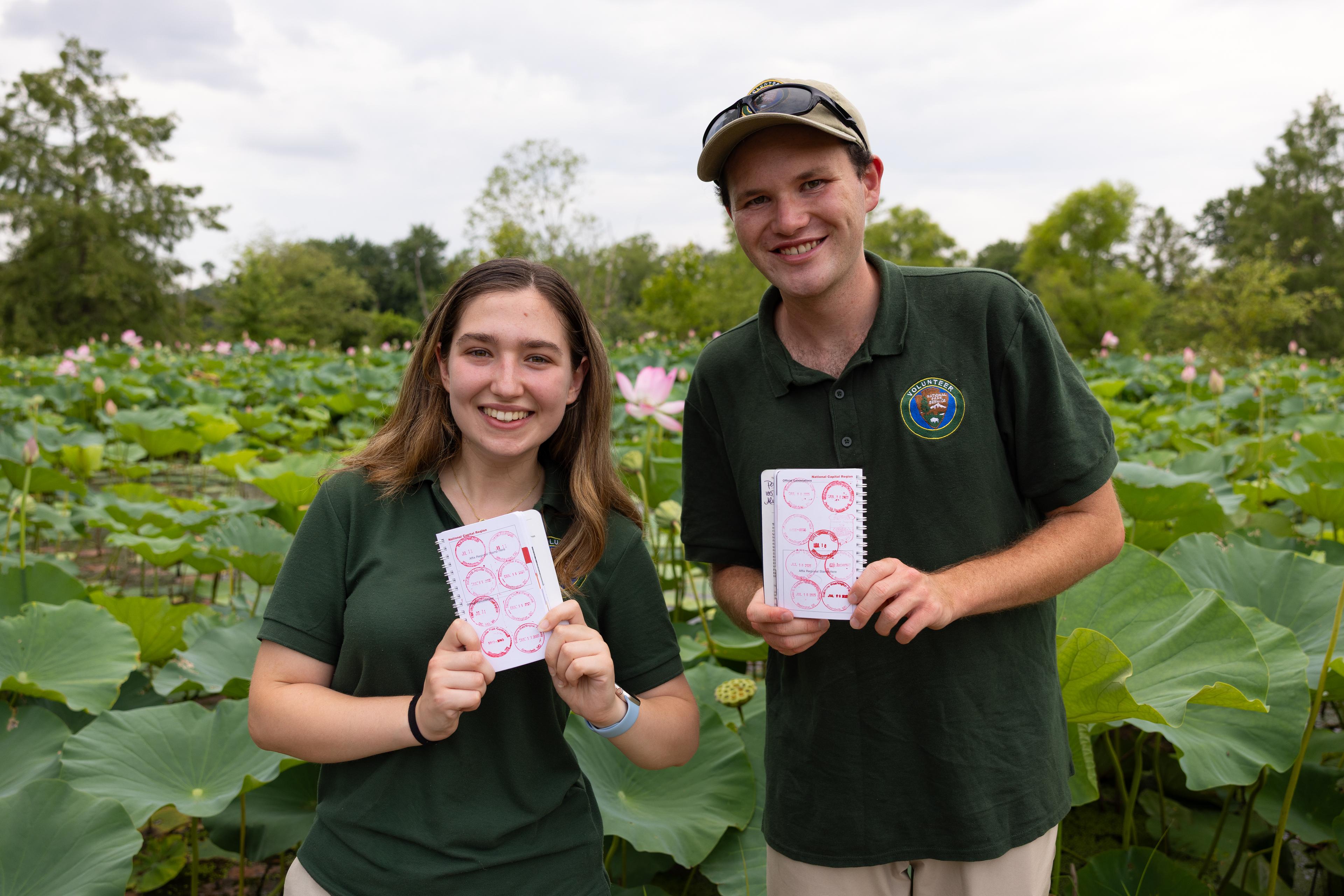 Two National Park Service interns show their passport stamp collection at Kenilworth Aquatic Gardens
